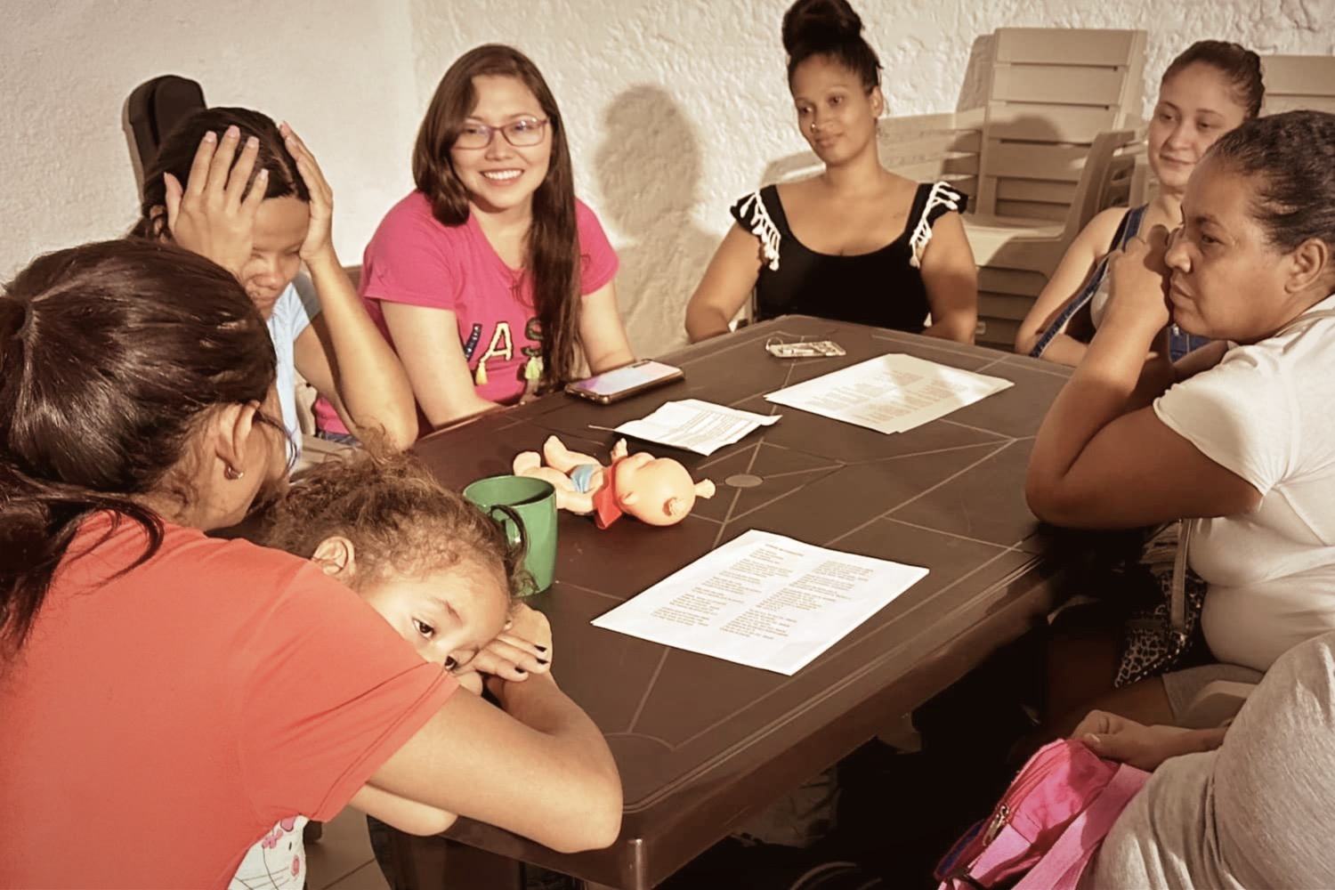 DJ facing a crowd at his deck. Photo with a purple hue